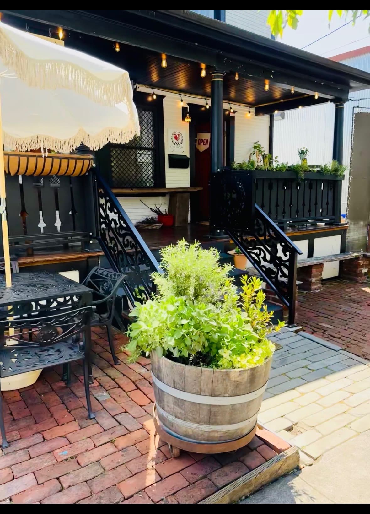 Wine bottle drippers in the railing planters at Coq au Vin Portland