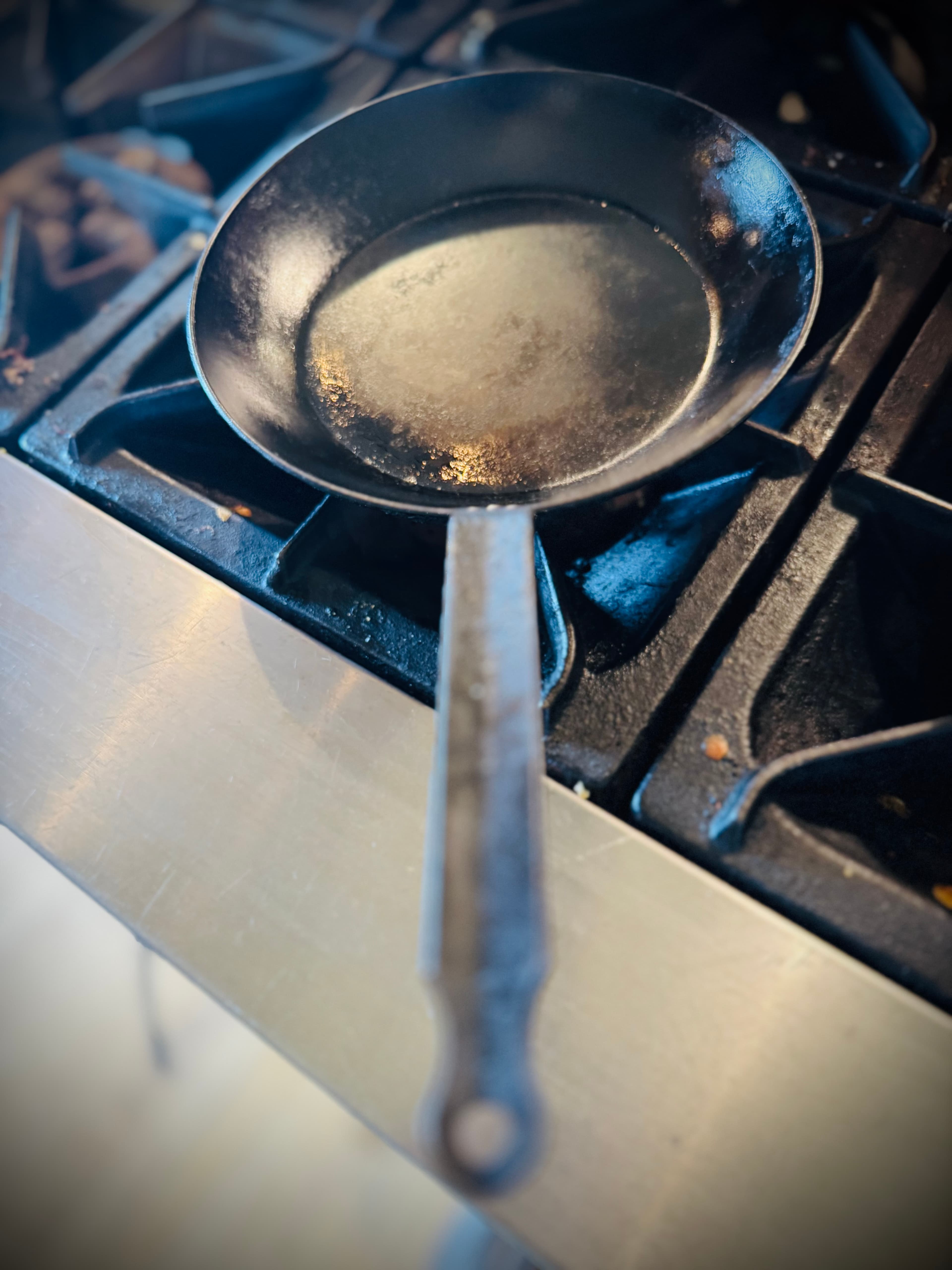 George’s cured black steel pan on the stove